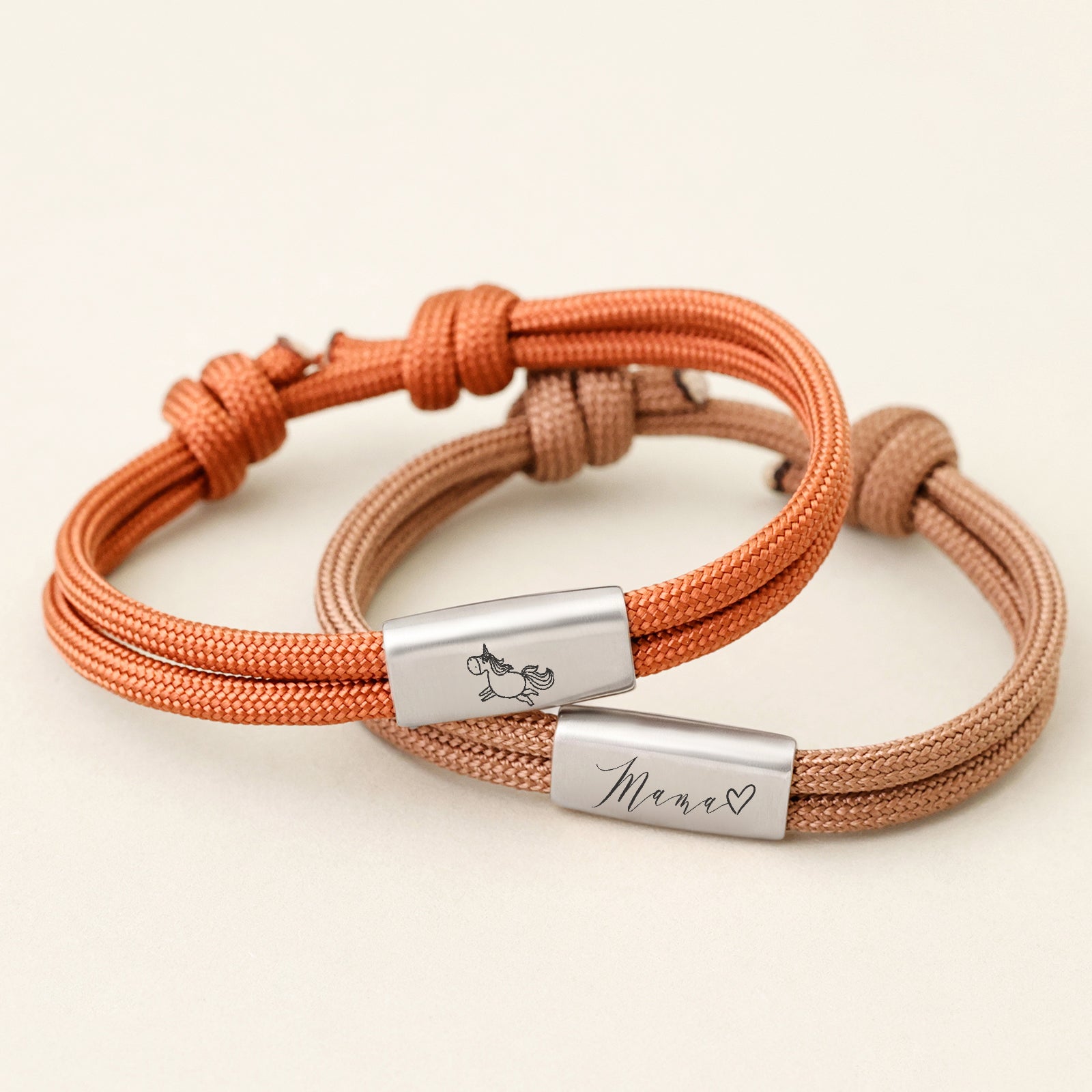 Zwei Segeltau Armbänder mit Wunschgravur in Orange und Braun, graviert mit Einhorn-Symbol und Mama