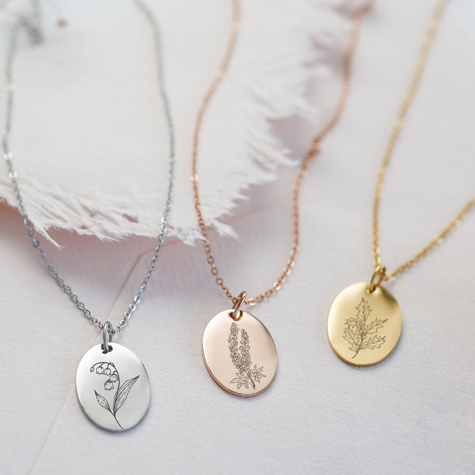 Personalized necklace with oval pendant and birth flowers